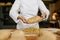 Baker shaping bread bagels with seeds