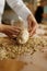 Baker shaping bread bagels with seeds