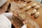 Baker shaping bread bagels with seeds