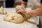 baker, shaping and scoring bread dough into whimsical shapes for special occasion