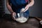 Baker sifting flour