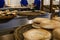 Baker sifting flour through a sieve in bakery shop.