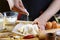 Baker sprinkle the dough with flour bread, pizza or pie recipe ingredients with hands, food on kitchen table background, working w