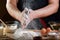 Baker sprinkle the dough with flour bread, pizza or pie recipe ingredients with hands, food on kitchen table background, working w