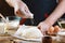 Baker sprinkle the dough with flour bread, pizza or pie recipe ingredients with hands, food on kitchen table background, working w