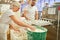 Baker team kneading small rolls in large bakery