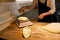 Baker weighing bread dough on scale at bakery