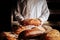 Baker in white jacket presenting wheat and rye gluten free bread