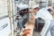 Baker woman getting bread out of bakery oven