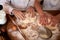 Bakers hands kneading the dough on the table