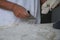 Bakers making handmade loaves of bread in a family bakery shaping the dough into tradional shapes. Working hands kneading bread