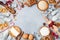 Bakery background with ingredients for cooking christmas baking decorated with fir tree. Flour, brown sugar, eggs and spices.