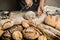 Bakery - baker`s hands sprinkle raw dough with flour