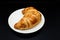 Bakery Croissant against a black background