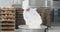 Bakery factory old man chef preparing the dough in a industrial container he add some flour while in background bakery