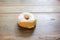 Bakery fresh doughnut soft and sweet delicious vanilla glazed frosted donut on wood table surface