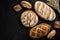 Bakery - gold rustic crusty loaves of bread and buns on black chalkboard background.