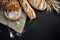 Bakery - gold rustic crusty loaves of bread and buns on black chalkboard background.