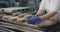 Bakery industry food factory details in the kitchen baker forming pieces of dough for baking bread in the oven machine