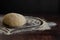 Bakery items - uncooked yeast dough on wooden flour background