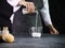 Bakery man pouring milk into a measuring jug in the kitchen at home, preparing bread dough, food homemade bakery concept