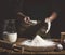 Bakery. Man preparing bread, Easter cake, Easter bread or cross-buns on wooden table in a bakery close up. Man preparing bread dou