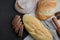 Bakery - rustic crusty loaves of bread and rolling pin on black chalkboard background. Still life captured from above.