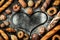 Bakery - various bread rolls arranged into a heart shape on black background