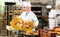 Bakery worker carrying box with loaves