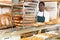 Bakery worker carrying trolley rack with baguettes