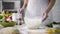 Bakery worker holding flour sieve for adding into glass bowl, pizza recipe tips