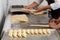 Bakery workers making crescent rolls