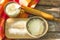 Baking background. Cooking ingredients for dough and pastry making and sprinkled with flour board on rustic wood. Top view with co