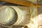 Baking background. Cooking ingredients for dough and pastry making and sprinkled with flour board on rustic wood. Top view with co