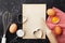 Baking background with flour, rolling pin, eggs, paper sheet and heart shape on kitchen table top view for Valentines day.Flat lay