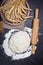 Baking background with flour, rolling pin and grain ears on black chalkboard