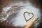 Baking background with the rolling pin, heart shape and flour on