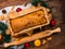 Baking cake with rolling pin on rural rustic wooden background flat lay. Dough recipe ingredients eggs wholegrain flour