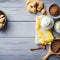 Baking cake in rural kitchen - dough recipe ingredients (eggs, flour, milk, butter, sugar and cinnamon) in ceramic bowls