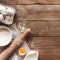 Baking concept flat lay. Ingredients, kitchen utensils, wooden background