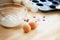 Baking cupcakes with eggs, flour and muffin tin on a wooden kitchen board, copy space