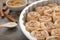 Baking dish with uncooked cinnamon rolls on kitchen table, closeup