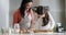 Baking, family and a mother with her daughter learning how to use a rolling pin while cooking in a kitchen. Bake, kids