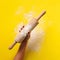 Baking flat lay with rolling pin, flour on yellow paper background. Bake menu, recipe, homemade pastry concept. Top view. Banner