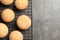 Baking grid with Danish butter cookies on grey background, top view.