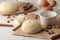 Baking ingredients. baking tools. dough and butter, eggs, sugar, milk, cinnamon, almonds on a white wooden background