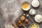 Baking ingredients and cooling rack on rustic beige background. View from above