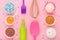 Baking ingredients, egg, flour, cocoa, sugar, sweet decoration and kitchen tools on pink background