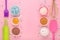 Baking ingredients, egg, flour, cocoa, sugar, sweet decoration and kitchen tools on pink background