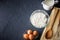 Baking ingredients - flour, milk, eggs with a whisk,